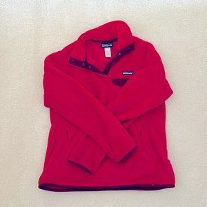 Women’s large Patagonia fleece pull over. Color is a deep coral.